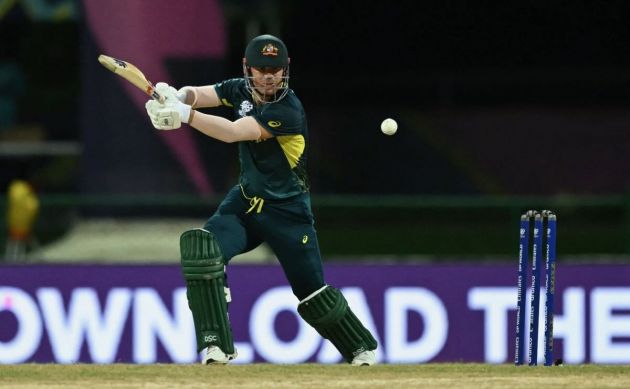 Australia's David Warner plays a shot during the ICC men's Twenty20 World Cup 2024 Super Eight cricket match between Australia and Bangladesh at Sir Vivian Richards Stadium in North Sound, Antigua and Barbuda, on June 20, 2024